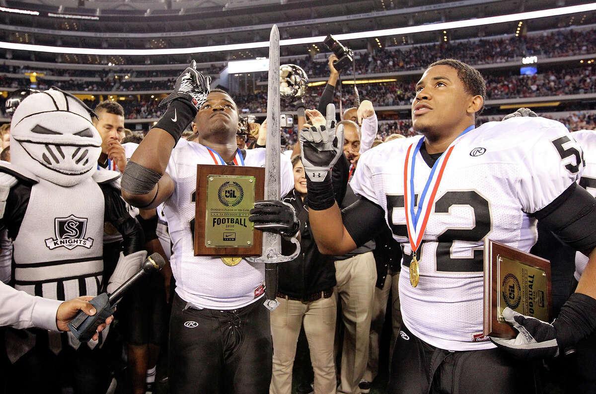 Steele Knights running back Malcolm Brown (left) and linebacker Ryan Simmons celebrate their 24-21 win over Denton Guyer in the Class 5A Division II state final Saturday at Cowboys Stadium in Arlington.