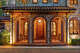 Lanterns add a warm glow to the brick, arched entryway at 603 W. Friar Tuck Lane.