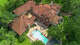 An aerial image of 603 W. Friar Tuck shows the pool terrace and tiled roof.