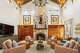 The great room features a soaring, beamed ceiling and floor-to-ceiling stone fireplace.