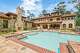 Stone and brick decking adds a Mediterranean-style touch to the pool and spa at 603 W. Friar Tuck.