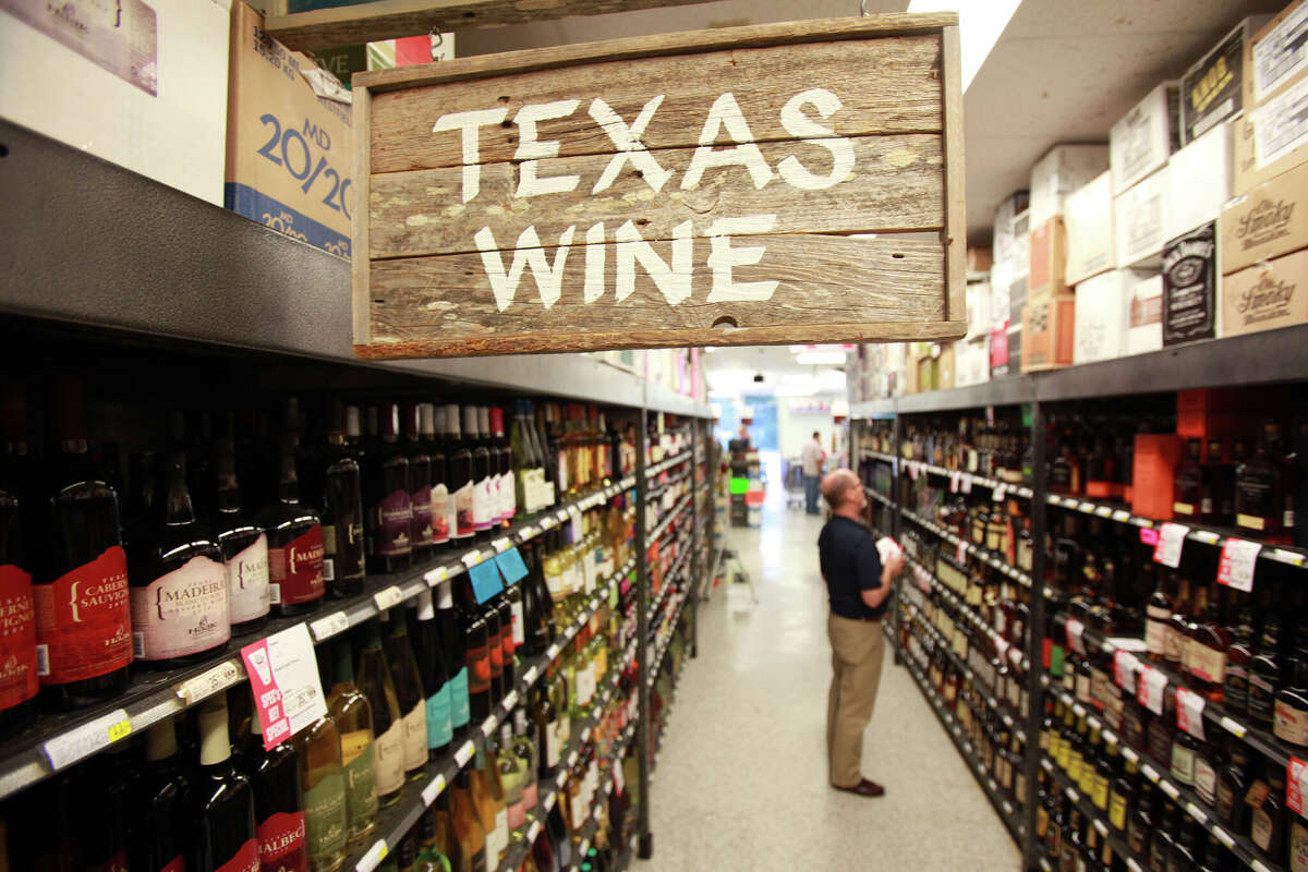 Texas Wine aisle at Spec's in Midtown on Friday, Aug. 16, 2013, in Houston. Texas winemakers using out-of-state grapes to make wine -- because the weather here has been so bad and they don't have enough Texas grapes. They cannot technically call it Texas wine if they use non-Texas grapes, so some winemakers try to hide the disclaimer so people think they're buying Texas wines. ( Mayra Beltran / Houston Chronicle ) (Photo by Mayra Beltran/Houston Chronicle via Getty Images)