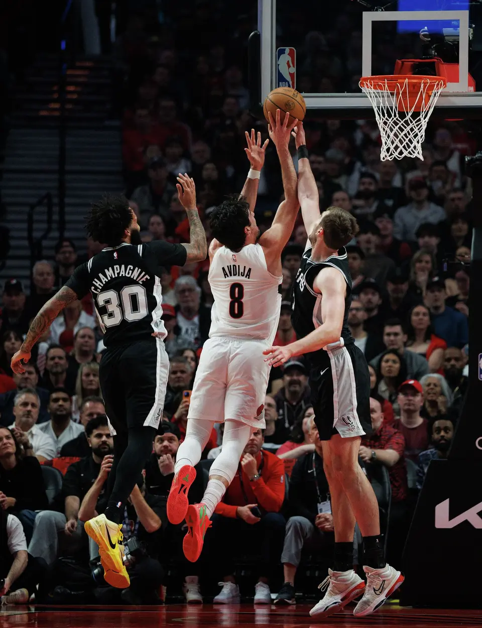 San Antonio Spurs center Luke Kornet (7) blocks a shot by Portland Trail Blazers forward Deni Avdija (8) during the first quarter of Game 3 of a first-round NBA playoff series at Moda Center in Portland, Friday, April 24, 2026.