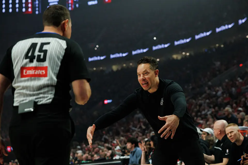 San Antonio Spurs head coach Mitch Johnson talks to referee Brian Forte (45) during the first quarter of Game 3 of a first-round NBA playoff series against the Portland Trail Blazers at Moda Center in Portland, Friday, April 24, 2026.