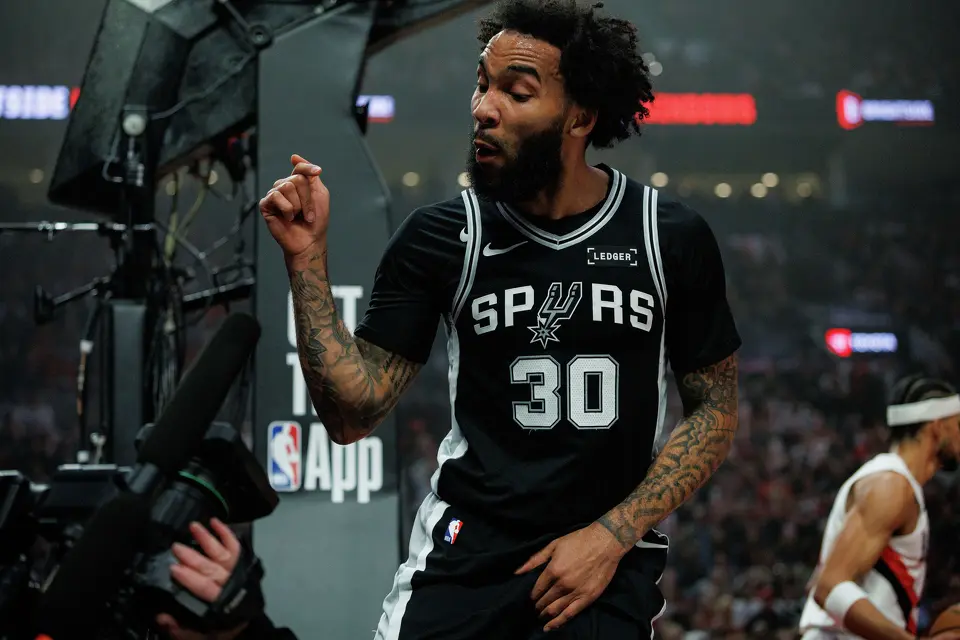 San Antonio Spurs forward Julian Champagnie (30) talks directly into a camera after making a shot against the Portland Trail Blazers during the first quarter of Game 3 of a first-round NBA playoff series at Moda Center in Portland, Friday, April 24, 2026.