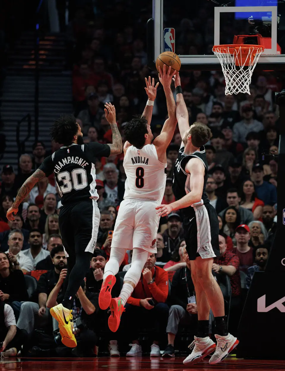 San Antonio Spurs center Luke Kornet (7) blocks a shot by Portland Trail Blazers forward Deni Avdija (8) during the first quarter of Game 3 of a first-round NBA playoff series at Moda Center in Portland, Friday, April 24, 2026.