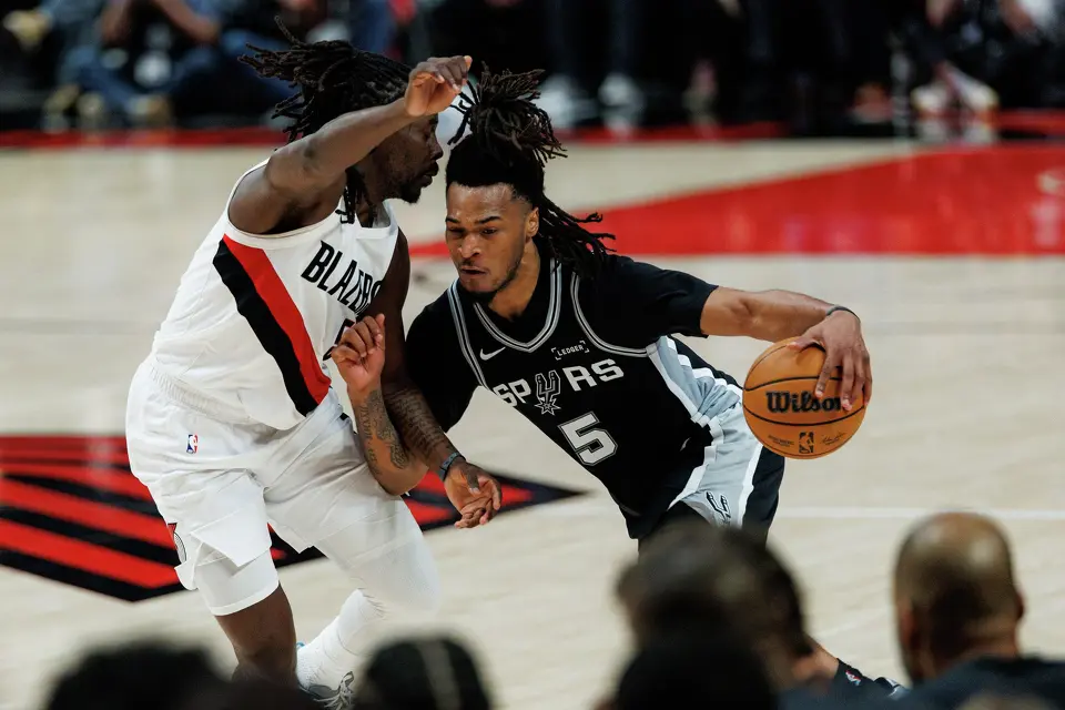 San Antonio Spurs guard Stephon Castle (5) drives around Portland Trail Blazers guard Jrue Holiday (5) during the second quarter of Game 3 of a first-round NBA playoff series at Moda Center in Portland, Friday, April 24, 2026.