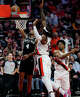San Antonio Spurs guard De'aaron Fox (4) goes up for a shot around Portland Trail Blazers center Robert Williams III (35) during the second quarter of Game 3 of a first-round NBA playoff series at Moda Center in Portland, Friday, April 24, 2026.