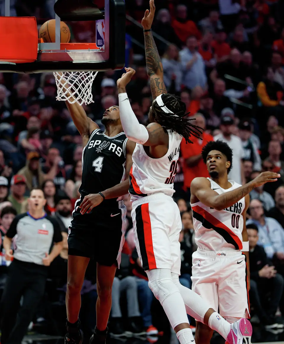San Antonio Spurs guard De'aaron Fox (4) goes up for a shot around Portland Trail Blazers center Robert Williams III (35) during the second quarter of Game 3 of a first-round NBA playoff series at Moda Center in Portland, Friday, April 24, 2026.