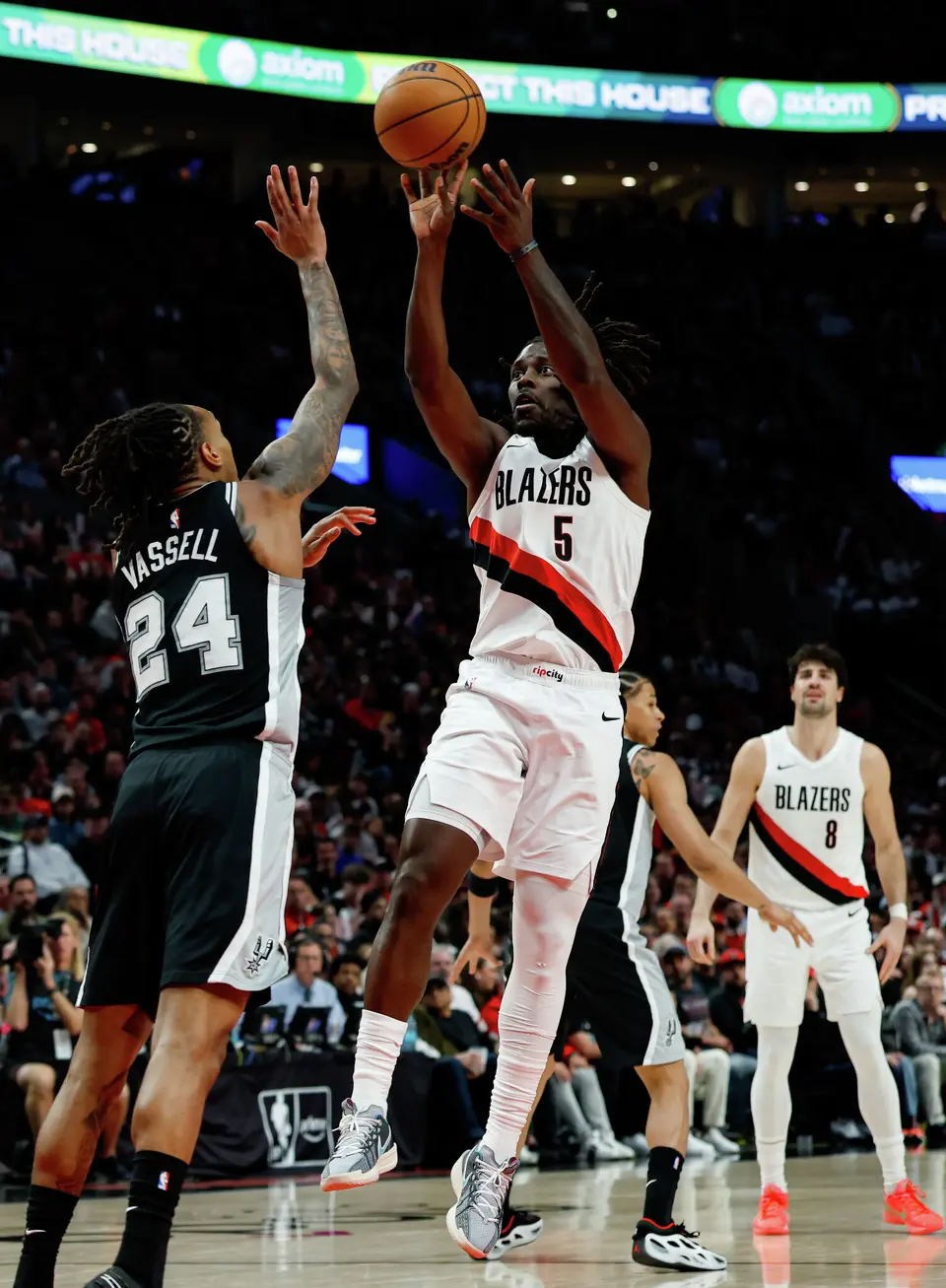 Portland Trail Blazers guard Jrue Holiday (5) shoots over San Antonio Spurs guard Devin Vassell (24) during the third quarter of Game 3 of a first-round NBA playoff series at Moda Center in Portland, Friday, April 24, 2026.