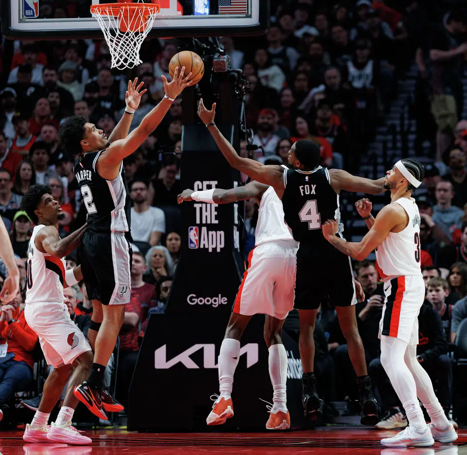 San Antonio Spurs guard Dylan Harper (2) rebounds the ball during the third quarter of Game 3 of a first-round NBA playoff series against the Portland Trail Blazers at Moda Center in Portland, Friday, April 24, 2026.