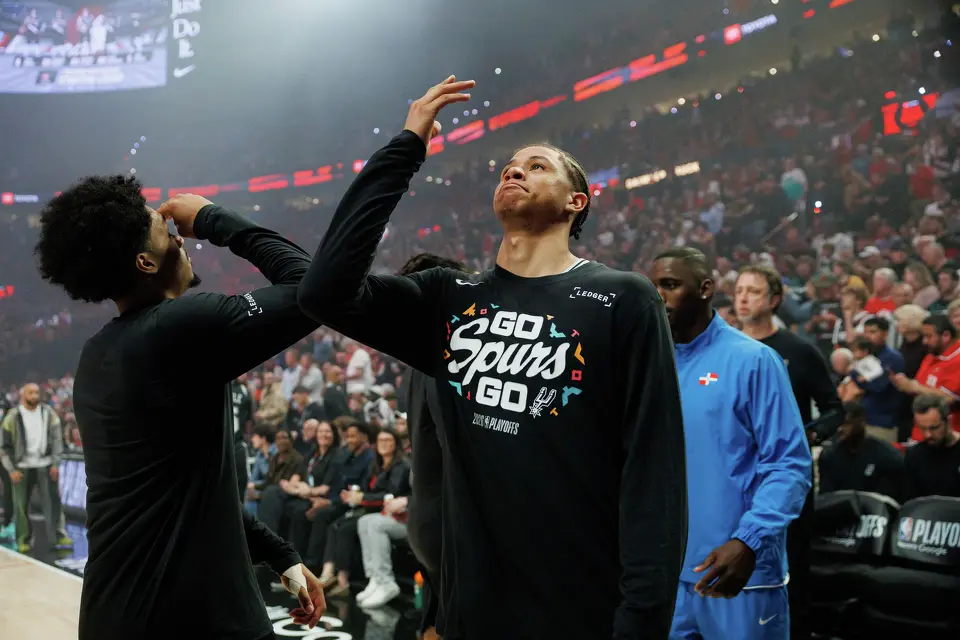 San Antonio Spurs guard Dylan Harper (2) and forward Carter Bryant (11) hype each other up before taking on the Portland Trail Blazers in Game 3 of a first-round NBA playoff series at Moda Center in Portland, Friday, April 24, 2026.