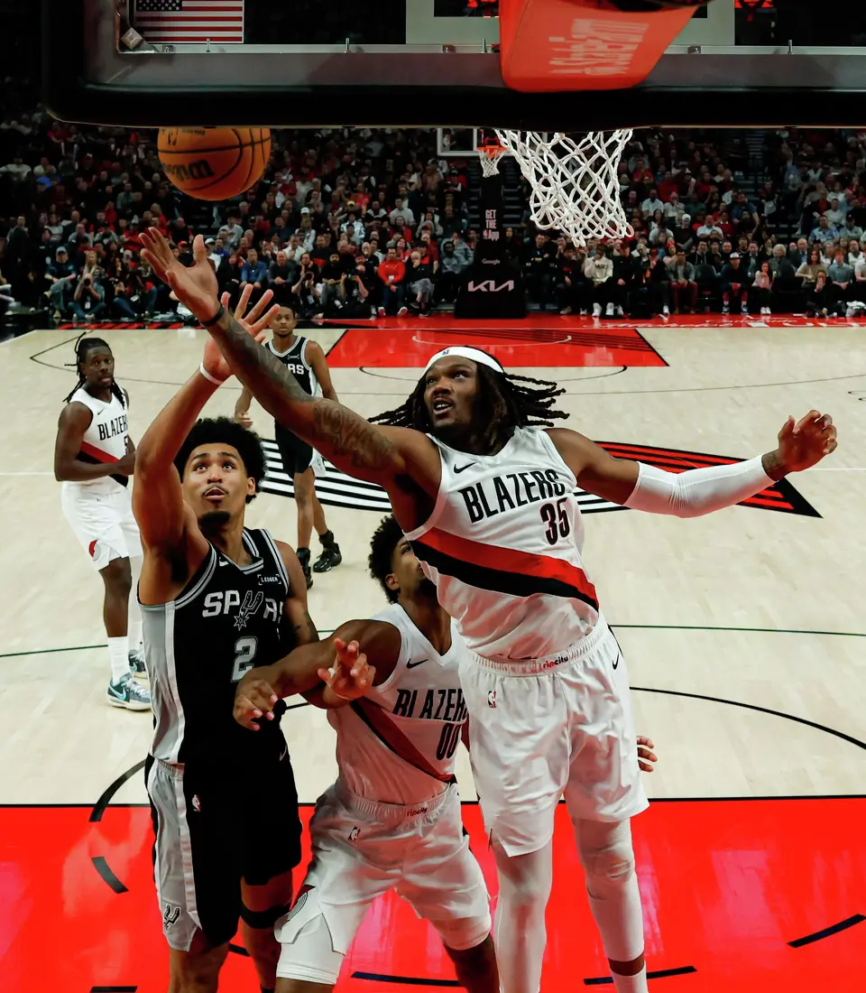 San Antonio Spurs guard Dylan Harper (2) and Portland Trail Blazers center Robert Williams III (35) go up for the rebound during Game 3 of a first-round NBA playoff series at Moda Center in Portland, Friday, April 24, 2026. The Spurs defeated the Trail Blazers 120-108 to lead the series 2-1.