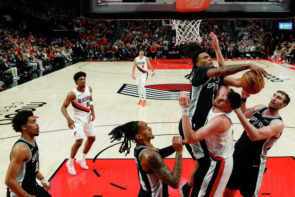 San Antonio Spurs guard Stephon Castle (5) goes up for the rebound above Portland Trail Blazers center Donovan Clingan (23) during Game 3 of a first-round NBA playoff series at Moda Center in Portland, Friday, April 24, 2026. Castle had 33 points, two rebounds and 5 assists, which helped lead the Spurs to a 120-108 victory.
