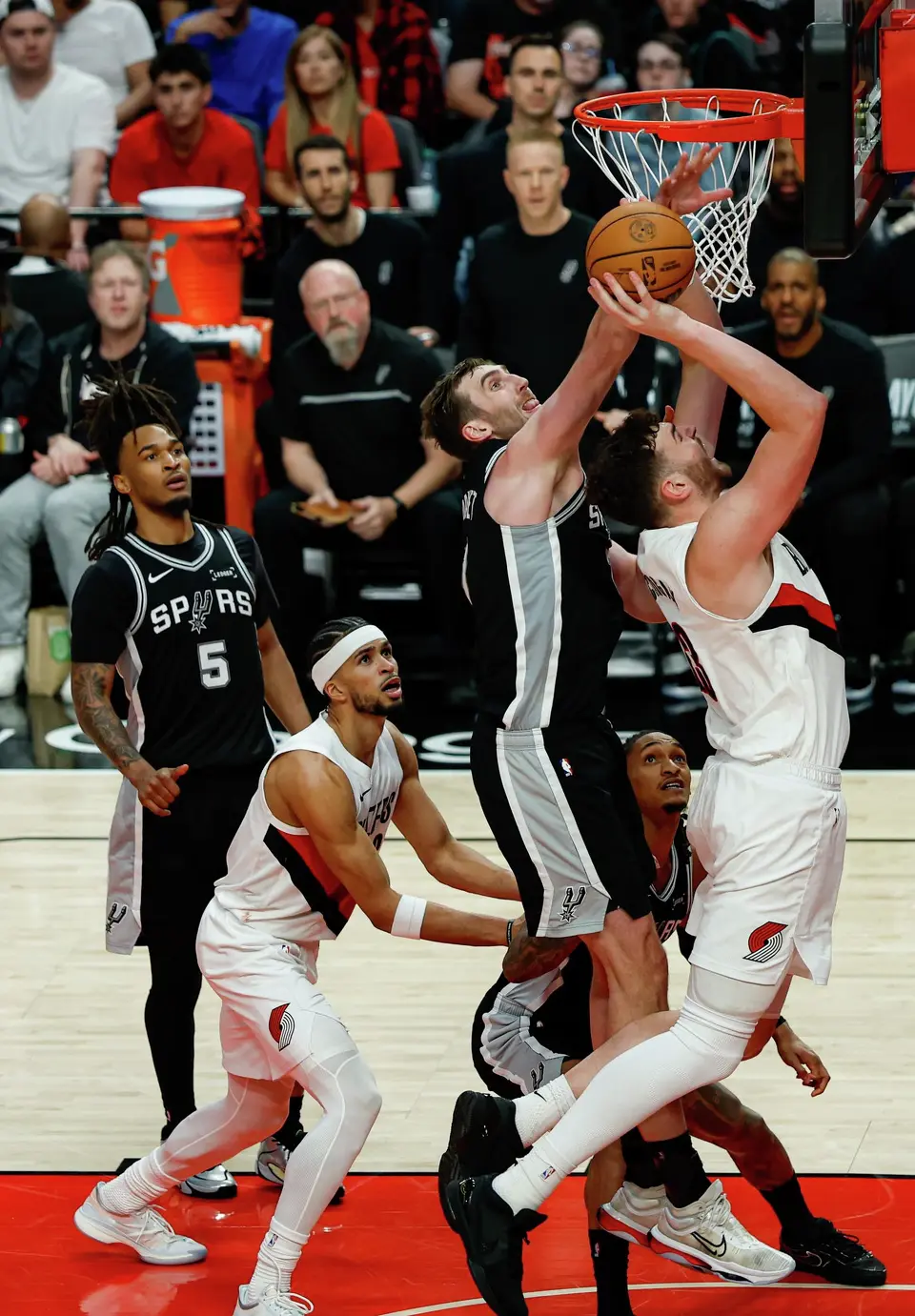 San Antonio Spurs center Luke Kornet (7) blocks a shot by Portland Trail Blazers center Donovan Clingan (23) during the fourth quarter of Game 3 of a first-round NBA playoff series at Moda Center in Portland, Saturday, April 25, 2026. The Spurs defeated the Trail Blazers 120-108 to lead the series 2-1.