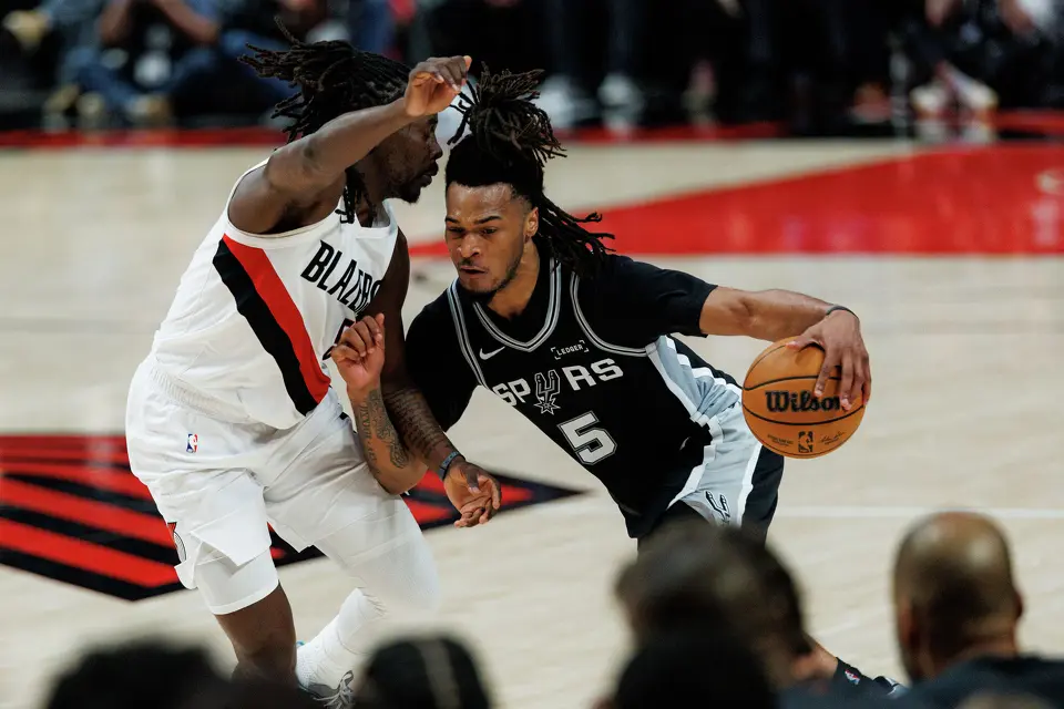 San Antonio Spurs guard Stephon Castle (5) drives around Portland Trail Blazers guard Jrue Holiday (5) during the second quarter of Game 3 of a first-round NBA playoff series at Moda Center in Portland, Friday, April 24, 2026.