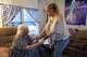 Sabrina Wellman, 56, helps her mother Diane Shields, 77, sit down in her lounge chair during a visit to Shield’s Fort Worth home, April 10, 2026. Shields said, if she gets to a point where cannot care for herself, her cats or home, Wellman has offered have her mother move into her house in Rowlett.