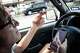 Scott Wheeler crosses his fingers hoping to make it through a stop light because his food delivery is due in three minutes in Dallas, March 31, 2026. Wheeler has a 97 percent DoorDash driver rating and is striving to achieve 100 percent. He hopes that he will receive better “offers” or higher paying deliveries with a perfect score.