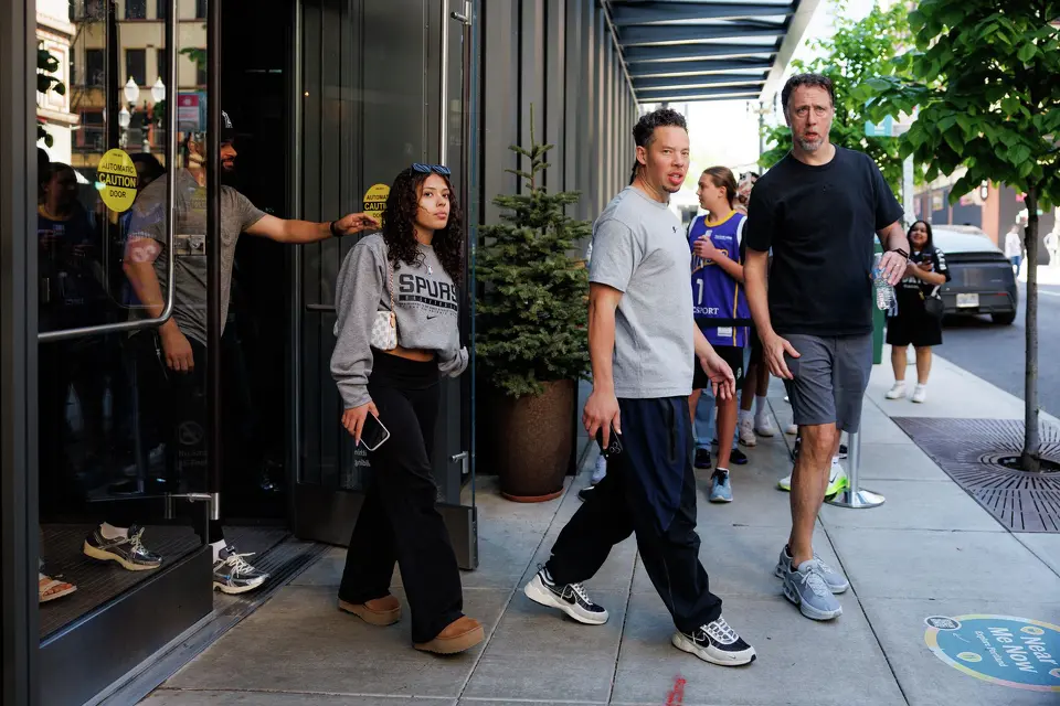 San Antonio Spurs head coach Mitch Johnson, second from right, and other members of the Spurs’ team walk out of the team hotel on their off day during a first-round NBA playoff series against the Portland Trail Blazers, Saturday, April 25, 2026, in Portland, Ore. The Spurs face the Trail Blazers in Game 4 on Sunday afternoon.