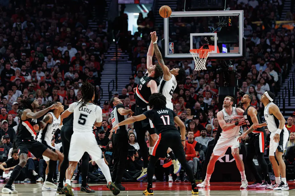 Portland Trail Blazers center Donovan Clingan (23) and San Antonio Spurs guard Dylan Harper (2) fight for a jump ball during the first quarter of Game 4 of a first-round NBA playoff series at Moda Center on Sunday, April 26, 2026.