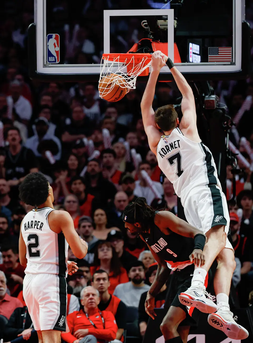 San Antonio Spurs center Luke Kornet (7) slams down a pass from San Antonio Spurs guard Stephon Castle (5) during the third quarter of Game 4 of a first-round NBA playoff series at Moda Center on Sunday, April 26, 2026.
