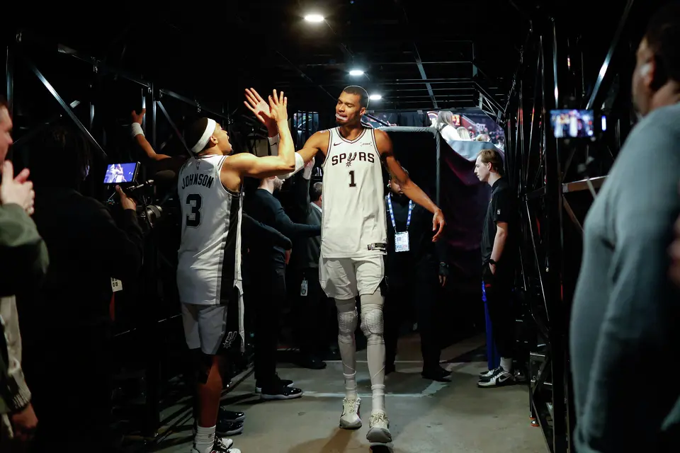 San Antonio Spurs forward Victor Wembanyama (1) slaps hands with San Antonio Spurs forward Keldon Johnson (3) as he walks back to the locker room following a post-game interview after Game 4 of a first-round NBA playoff series against the Portland Trail Blazers at Moda Center on Sunday, April 26, 2026. The Spurs won 114-93, leading the series 3-1.