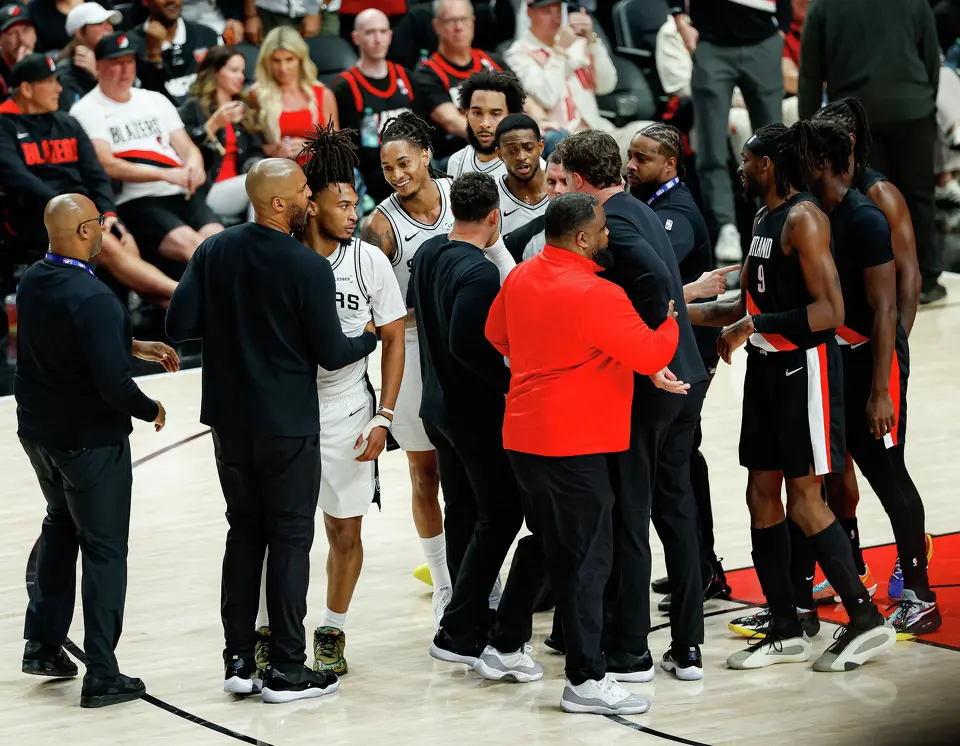 Players and staff swarm the court after a fight broke out between Portland Trail Blazers forward Deni Avdija (8) and San Antonio Spurs guard Stephon Castle (5) during the fourth quarter of Game 4 of a first-round NBA playoff series at Moda Center on Sunday, April 26, 2026. Castle and Avdija both received technical fouls. The Spurs won 114-93, leading the series 3-1.Players