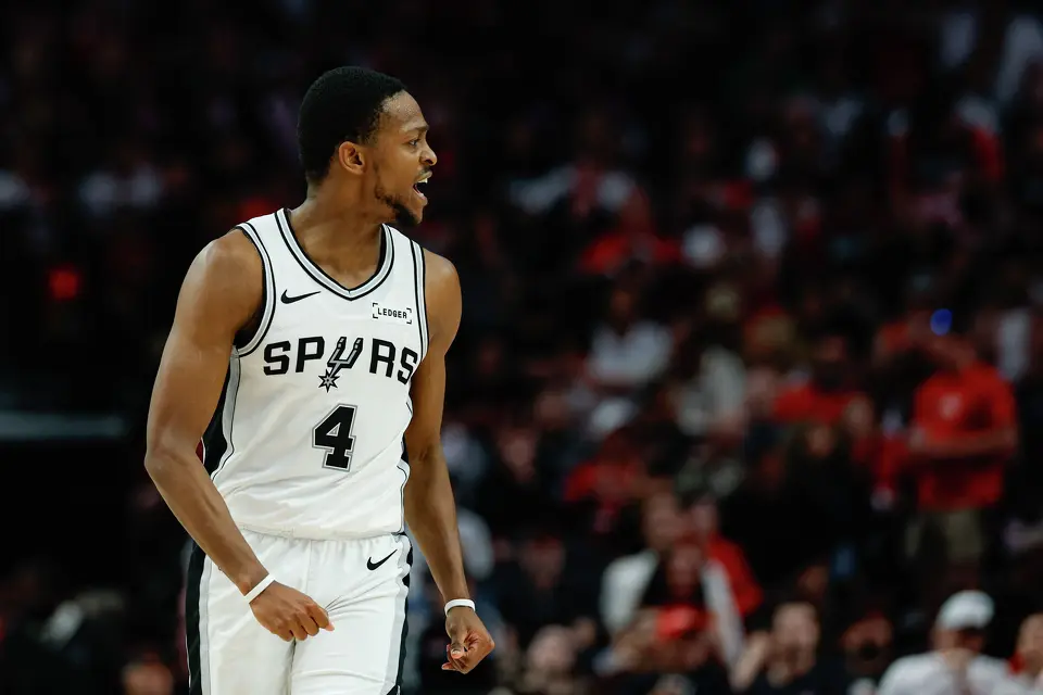 San Antonio Spurs guard De'aaron Fox (4) reacts after making a 3-pointer during the third quarter of Game 4 of a first-round NBA playoff series against the Portland Trail Blazers at Moda Center on Sunday, April 26, 2026.