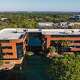 Large building surrounded by trees. SFA Saniflo above-floor plumbing systems address the needs of a building reuse project.