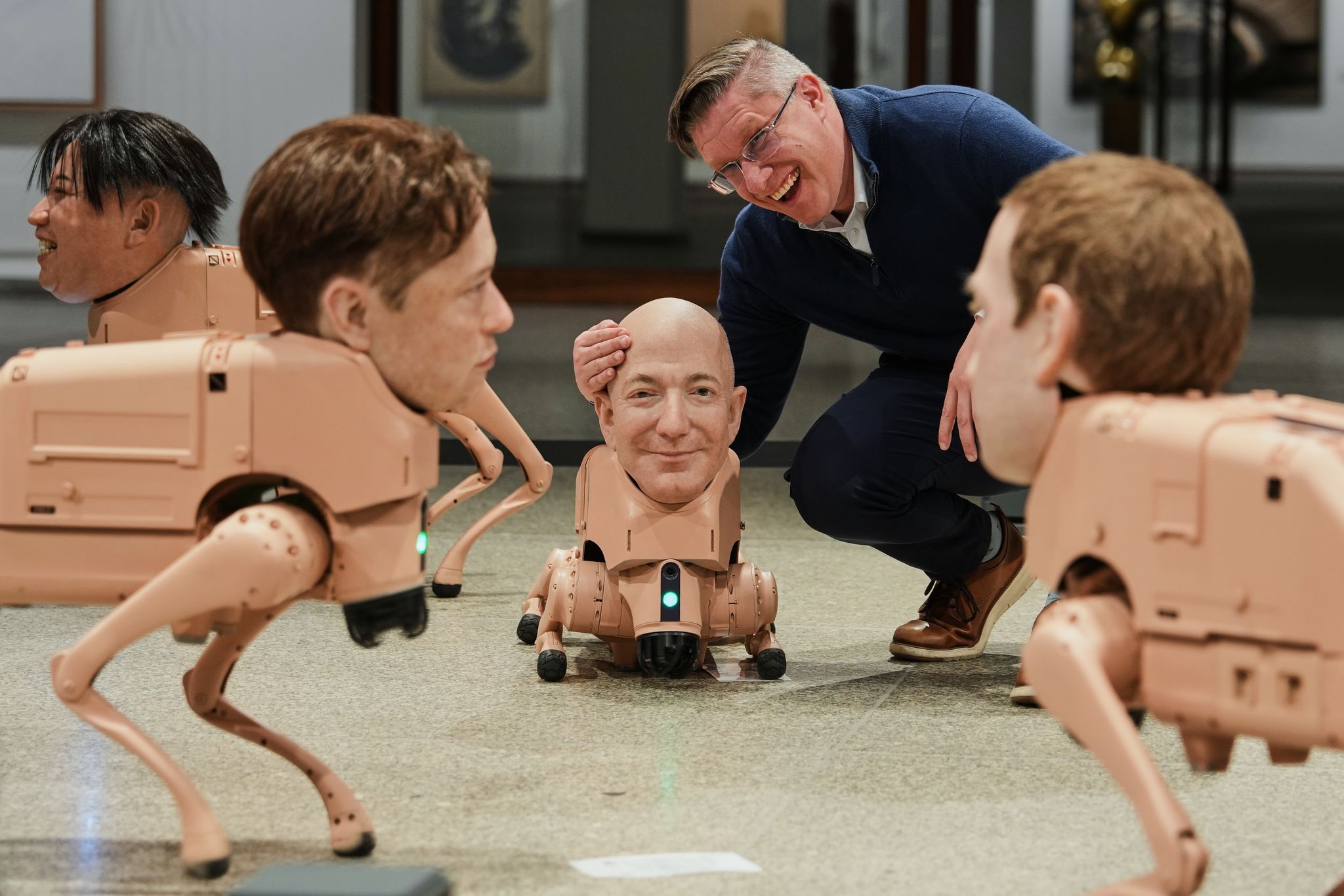 Robot dogs with Musk and Zuckerberg heads roam around Berlin gallery in...