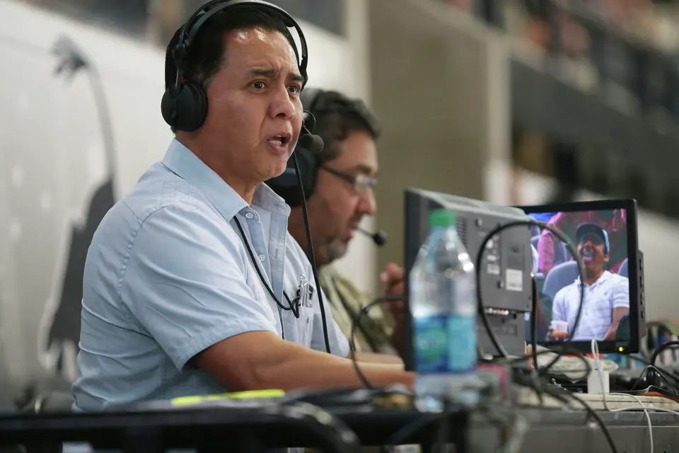 Radio broadcaster Paul Castro goes on the air from his perch above the arena as the Spurs host the Phoenix Suns at the AT&T Center on October 20, 2015.