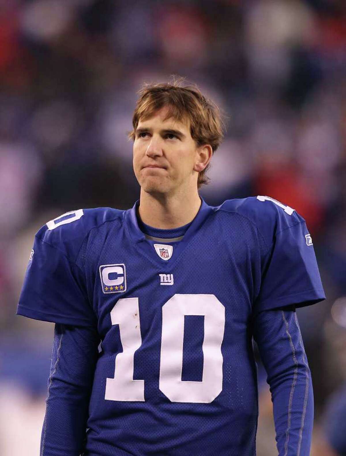 EAST RUTHERFORD, NJ - DECEMBER 19: Eli Manning #10 of the New York Giants walks off the field dejected after losing to the Philadelphia Eagles 38-31 on December 19, 2010 at The New Meadowlands Stadium in East Rutherford, New Jersey. (Photo by Al Bello/Getty Images) *** Local Caption *** Eli Manning