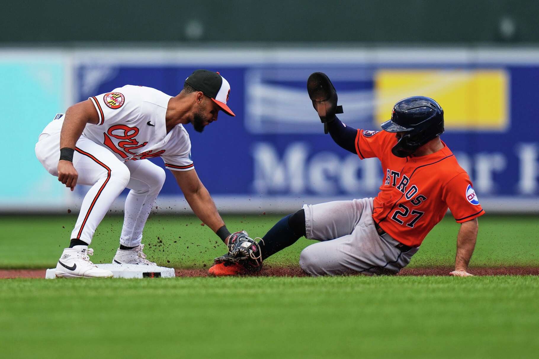 Houston Astros' Jose Altuve (27) is caught stealing second base by Baltimore Orioles second baseman Jeremiah Jackson, left, during the second inning in the first baseball game of a doubleheader, Thursday, April 30, 2026, in Baltimore. (AP Photo/Stephanie Scarbrough)