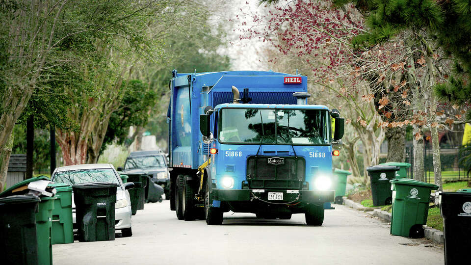 One of the city’s new solid waste vehicles collects trash on Merrill St in the Heights on February 19, 2026.