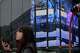 A person stands in front of an electronic stock board showing Japan's Nikkei index at a securities firm Thursday, April 30, 2026, in Tokyo.