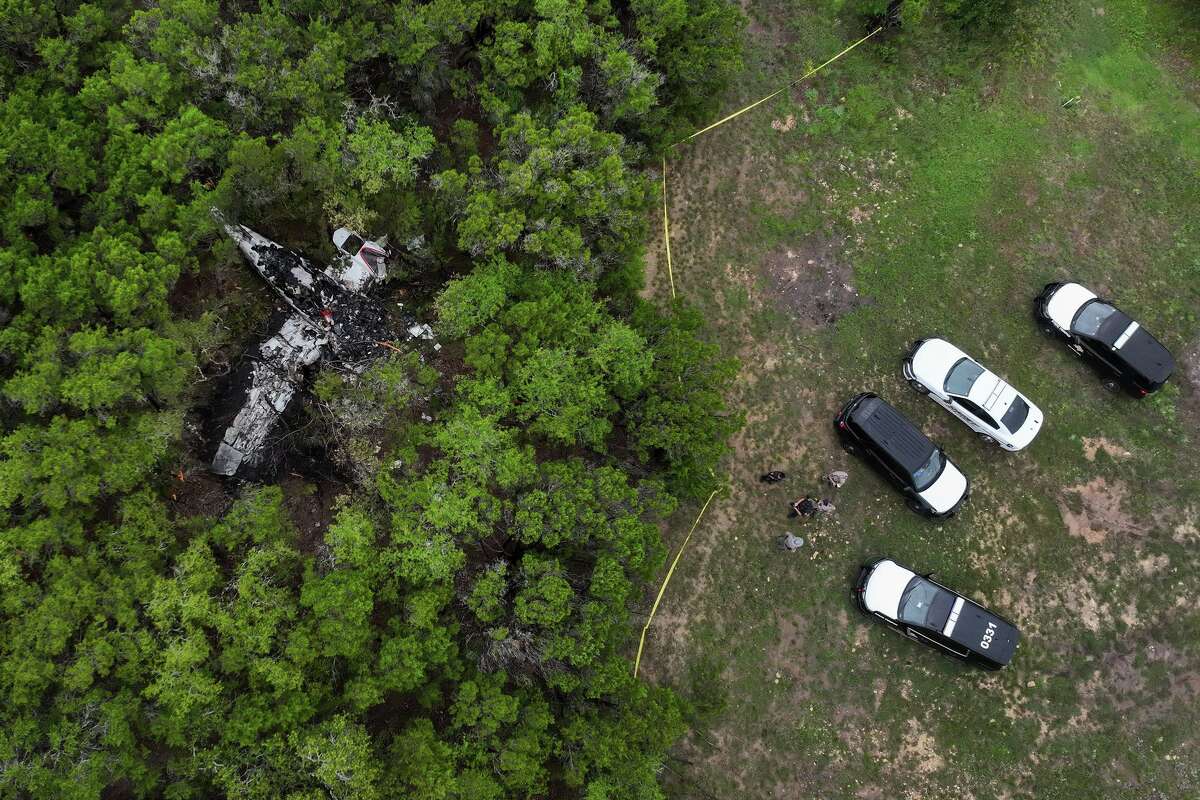 A crashed Cessna airplane is seen in a wooded area on Round Rock Road in Wimberley, Texas, Friday, May 1, 2026. (Jay Janner/Austin American-Statesman via AP)