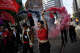 Shuci Zhang, right, and Sedona from Black Rose Anarchist Federation march together on May Day to advocate for workers’ rights and opposing deportations, job cuts, and war, on Market Street in San Francisco, May 1, 2026.