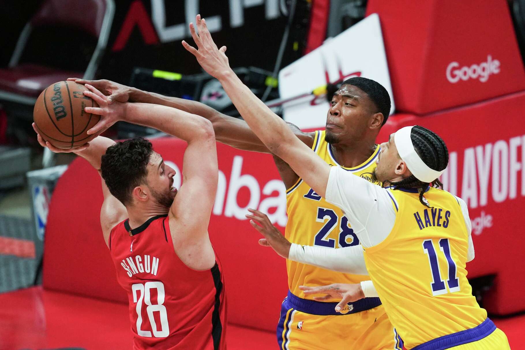 Houston Rockets center Alperen Sengun (28) is pressured by Los Angeles Lakers forward Rui Hachimura (28) and center Jaxson Hayes (11) during the first half in Game 6 of a first-round NBA playoff basketball series at Toyota Center in Houston on Friday, May 1, 2026.