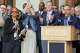 House Democrats applaud a revised $28.6 billion state budget during a news conference outside the state Capitol in Hartford on Saturday before the House granted final approval to the amended spending and tax package.
