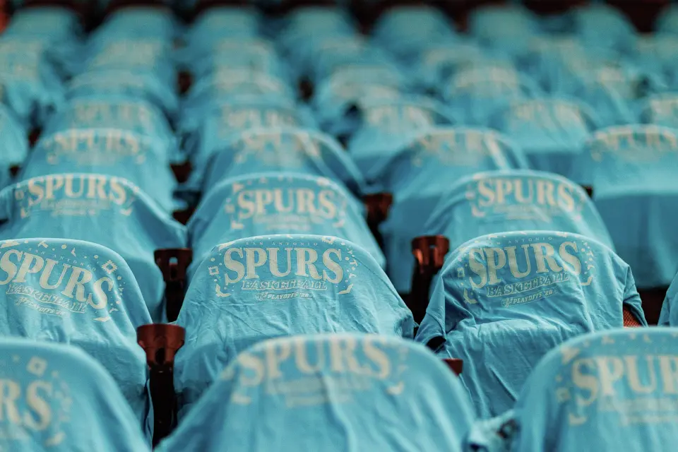 Fiesta-themed T-shirts are laid out on seats for fans before Game 1 of the Western Conference semifinals between the San Antonio Spurs and the Minnesota Timberwolves at Frost Bank Center in San Antonio on Monday, May 4, 2026.