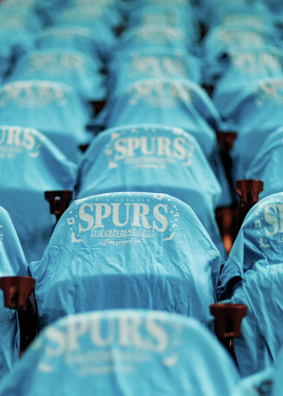 Fiesta-themed T-shirts are laid out on seats for fans before Game 1 of the Western Conference semifinals between the San Antonio Spurs and the Minnesota Timberwolves at Frost Bank Center in San Antonio on Monday, May 4, 2026.