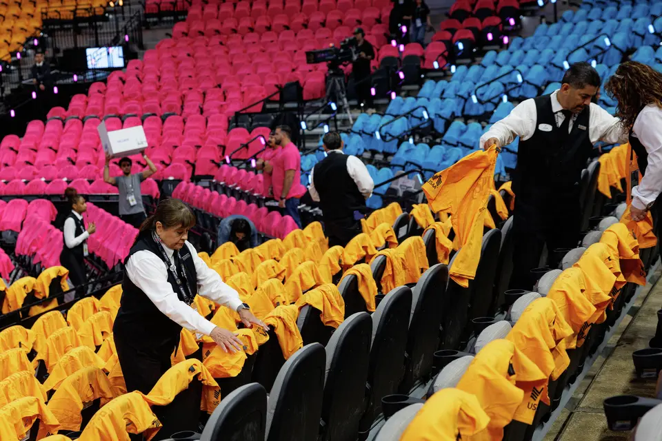 Spurs Sports & Entertainment employees arrange Fiesta-themed t-shirts on seats for fans before the start of Game 1 of the Western Conference semifinals between the San Antonio Spurs and the Minnesota Timberwolves at Frost Bank Center in San Antonio, Monday, May 4, 2026.