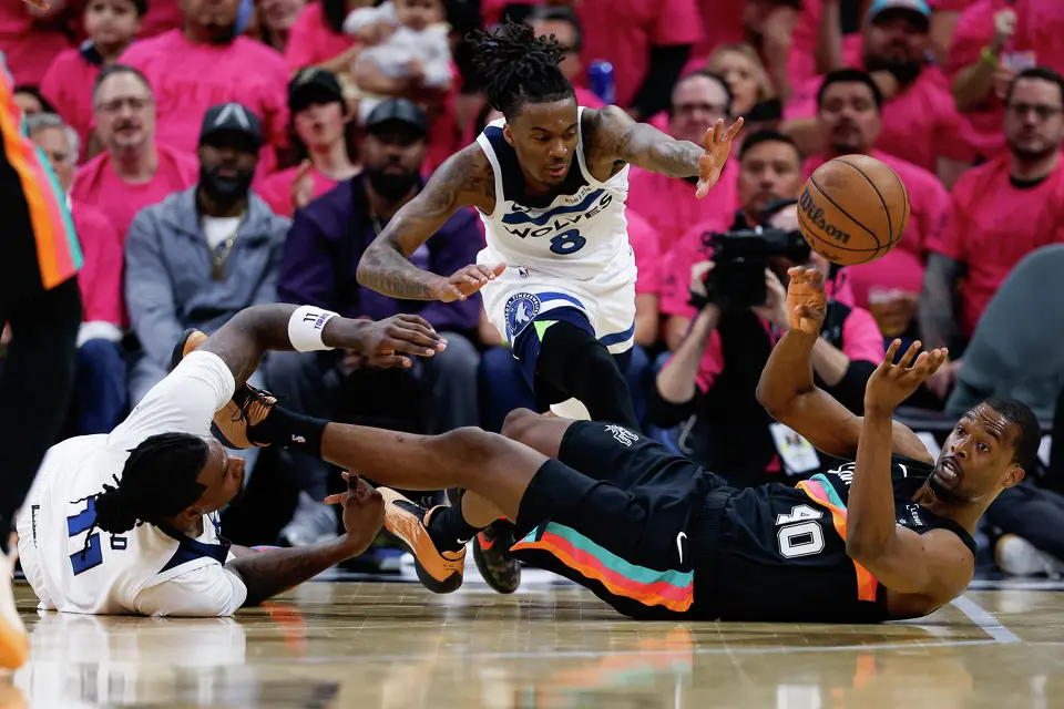 San Antonio Spurs forward Harrison Barnes (40) makes a pass after grabbing a loose ball around Minnesota Timberwolves center Naz Reid (11) and guard Bones Hyland (8) during the first half of Game 1 of the Western Conference semifinals at Frost Bank Center in San Antonio, Monday, May 4, 2026.