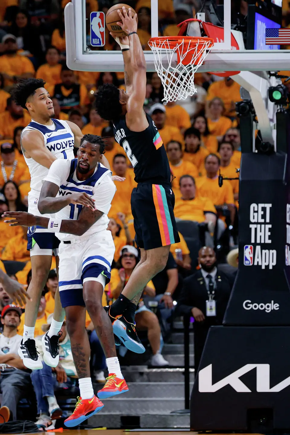 San Antonio Spurs guard Dylan Harper (2) dunks on the Minnesota Timberwolves during the first half of Game 1 of the Western Conference semifinals at Frost Bank Center in San Antonio, Monday, May 4, 2026.