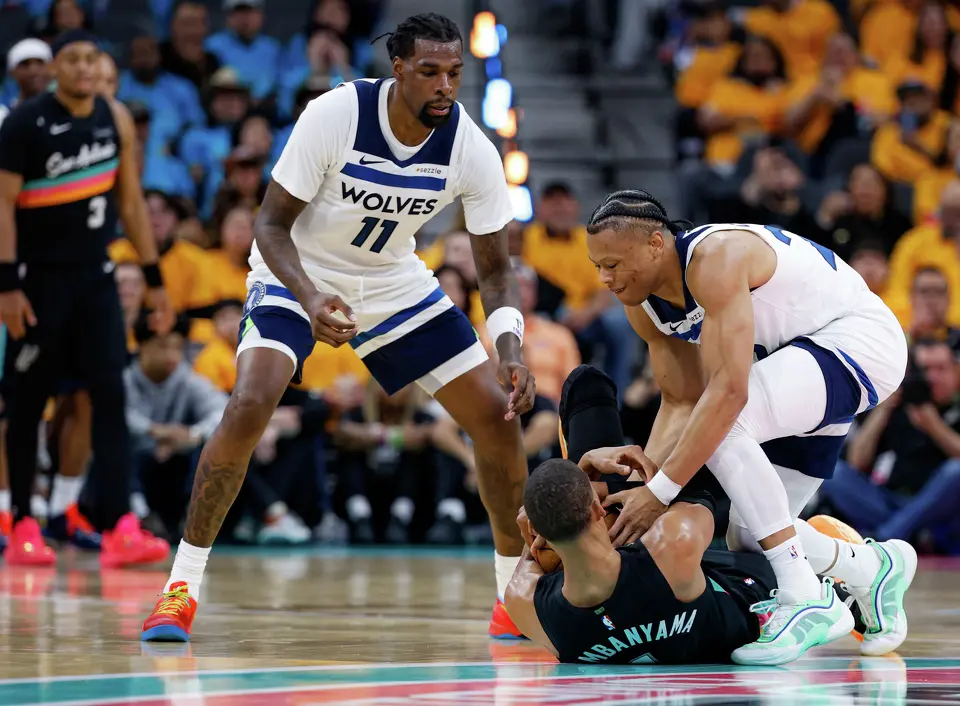 San Antonio Spurs forward Victor Wembanyama (1) and Minnesota Timberwolves guard Jaylen Clark (22) fight for the ball during the first half of Game 1 of the Western Conference semifinals at Frost Bank Center in San Antonio, Monday, May 4, 2026.