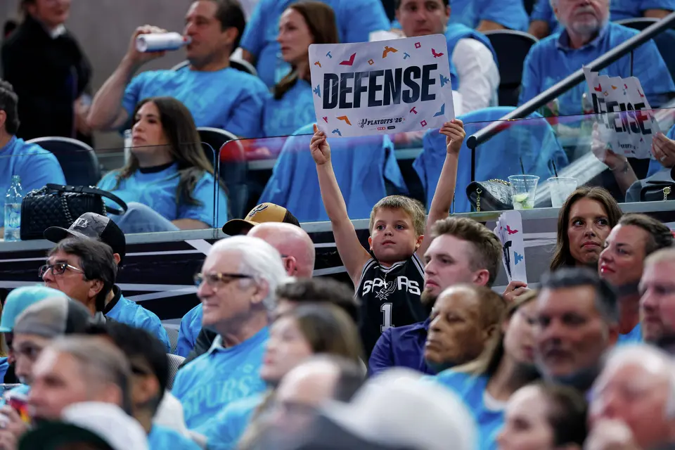 A young fan holds up a sign reading “defense” during the first half of Game 1 of the Western Conference semifinals between the San Antonio Spurs and the Minnesota Timberwolves at Frost Bank Center in San Antonio, Monday, May 4, 2026.