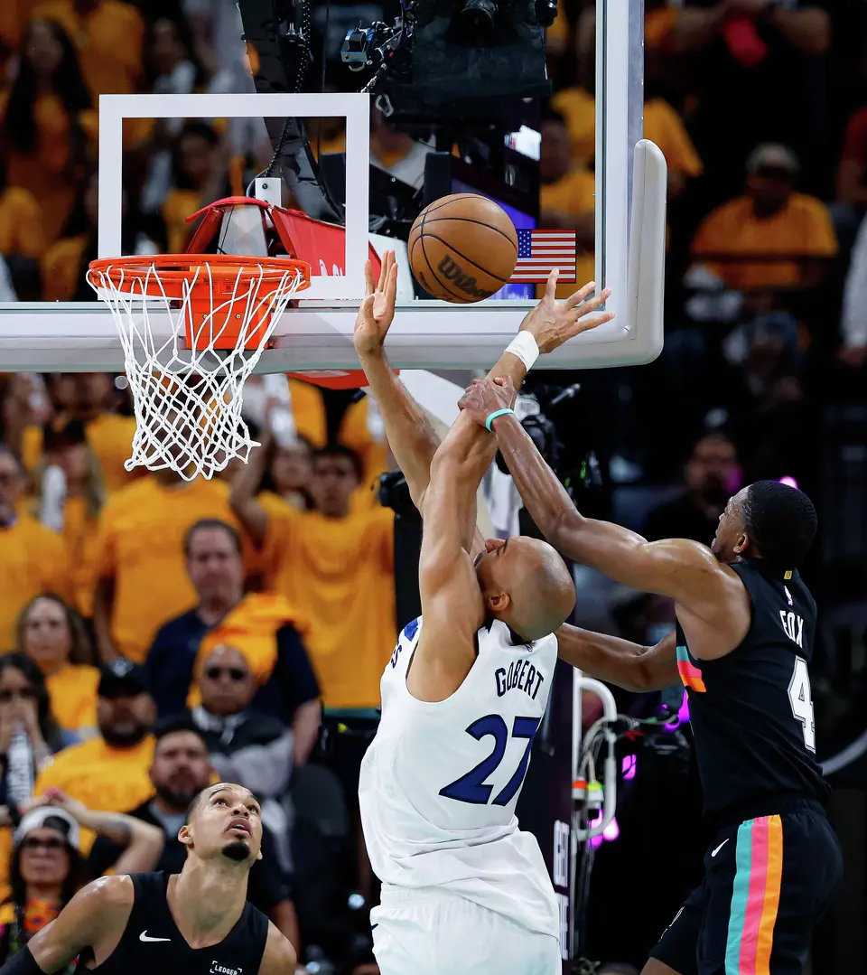 San Antonio Spurs guard De'aaron Fox (4) fouls Minnesota Timberwolves center Rudy Gobert (27) as he goes up for a shot during the fourth quarter of Game 1 of the Western Conference semifinals at Frost Bank Center in San Antonio, Monday, May 4, 2026. The Spurs fell 104-102 to the Timberwolves.