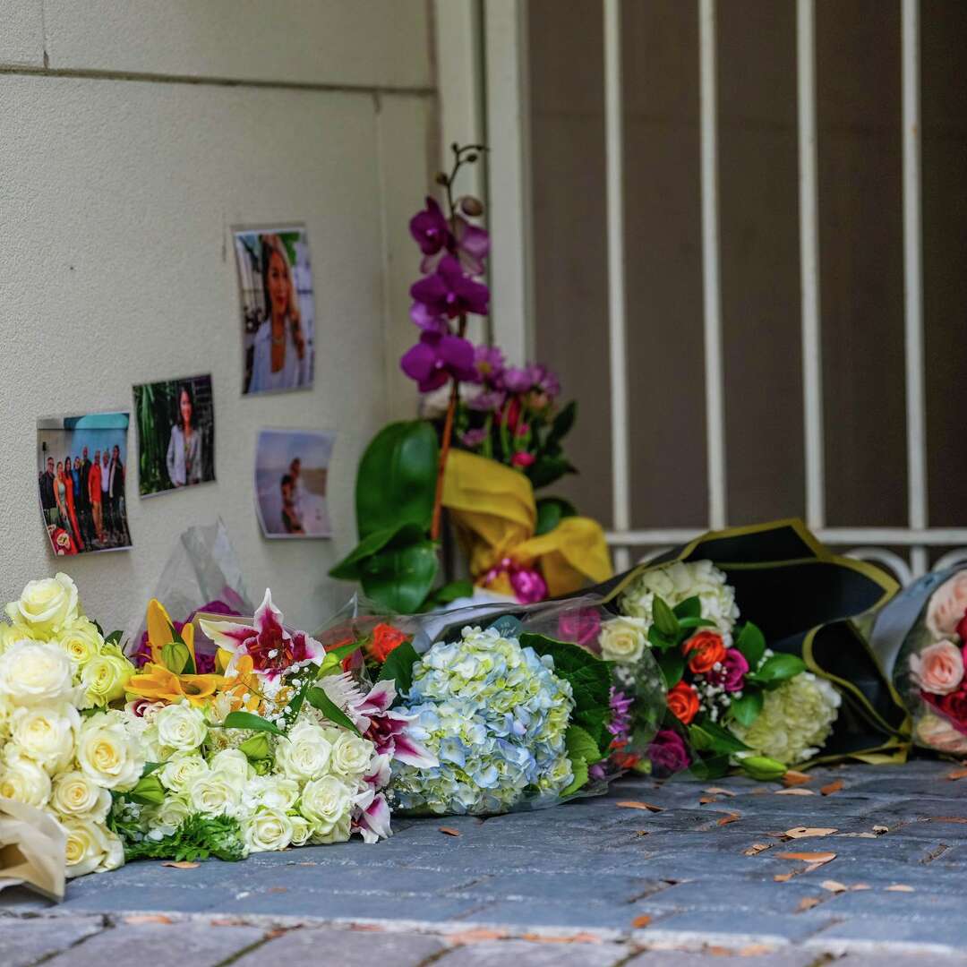 Photos and bouquets are seen in front of a River Oaks home where police found a family of four dead with gunshot wounds in Houston, Tuesday, May 5, 2026.