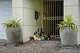 Photos and bouquets are seen in front of a River Oaks home where police found a family of four dead with gunshot wounds in Houston, Tuesday, May 5, 2026.