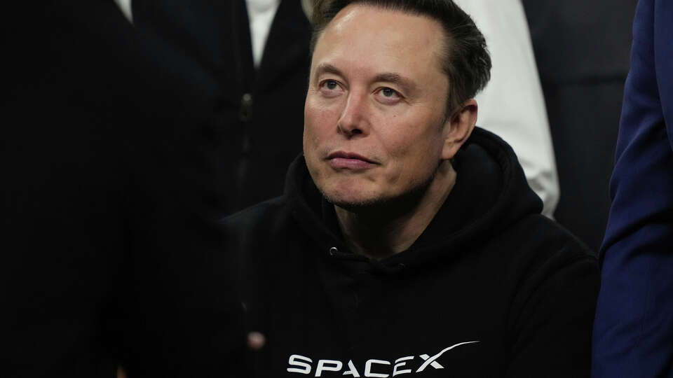 Elon Musk, pictured attending the finals for the NCAA wrestling championship in Philadelphia on March 22, 2025, is considering a site outside of College Station to build his 'Terafab' chip manufacturing plant.